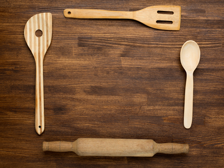 Wooden kitchen tools on vintage wooden background. Top view.の写真素材