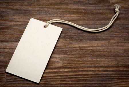 the blank price tag label on wooden background close up.の写真素材