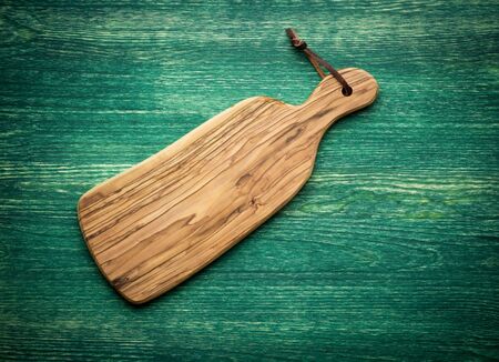 composition with olive wood board on top of oak table, rustic backgroundの写真素材