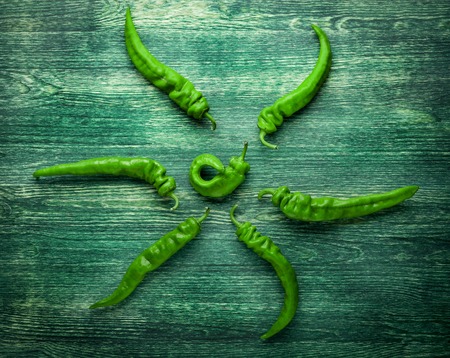 hot chili peppers on wooden background. Top viewの写真素材