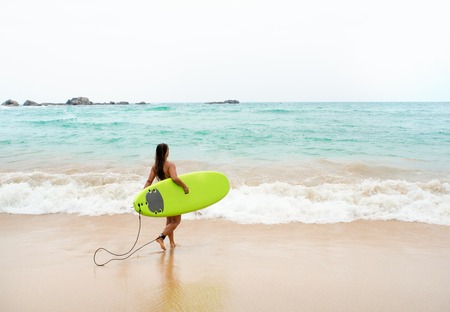 Beautiful sexy surfer girl on the beach.の写真素材