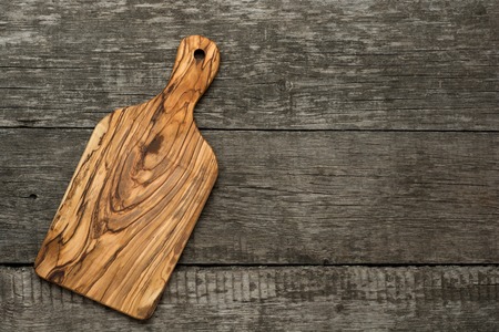 Wood chopping board on wooden background. Top viewの写真素材