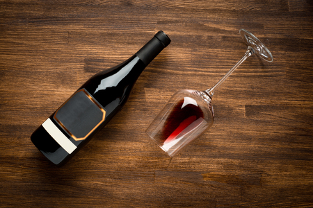 a bottle of wine and wine glass on old wood background. Food background.の写真素材
