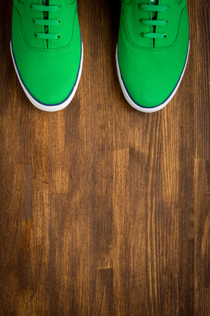 Outfit of traveler, student, teenager, young woman or guy. Colorful sneakers on wooden .の写真素材