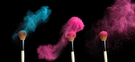 powderbrush on black background with blue powder splash  close upの写真素材