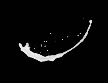 milk or white liquid splash isolated on black background.の写真素材