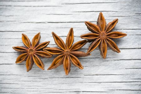 Spices. Anise stars on the vintage wooden background.の写真素材