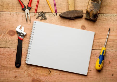 Set of tools over a wood panel with space for text.の写真素材