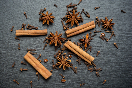Cinnamon sticks, anise on a stone plate. Top viewの写真素材