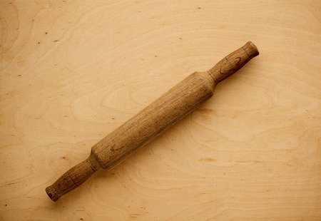 Wooden rolling pin over wood background, above view.の写真素材