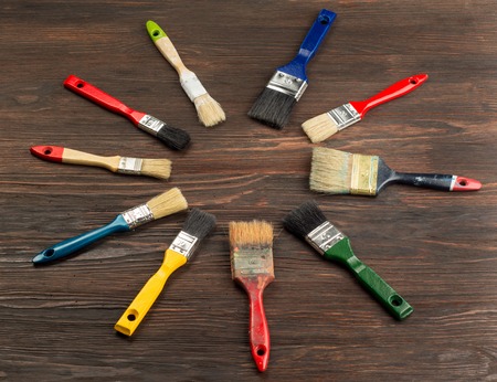 Set of paint brush on dark wooden background. Top view.の写真素材