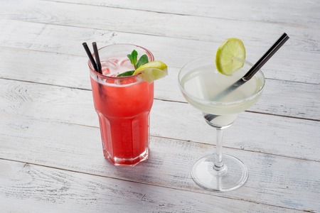 Cocktails set. Margarita, red alcohol cocktail on wooden background close up .の写真素材