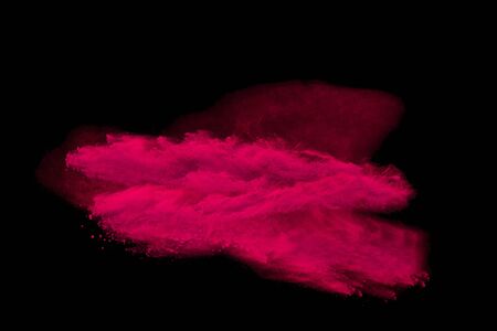 Explosion of colored powder explosion on black background.の写真素材