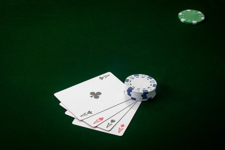 four kings on green background with poker chips.の写真素材