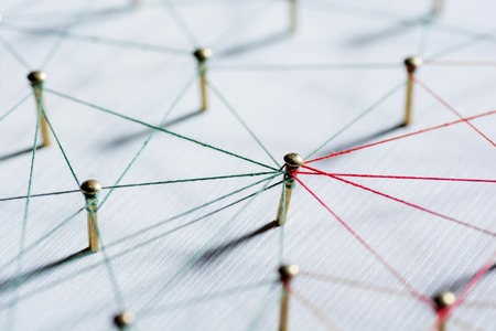 Background. Abstract concept idea of network, social media, internet, teamwork, communication. Thumbtacks linked together by red thread. Isolated. Entities connected.の写真素材