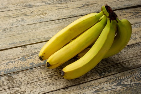Tasty fresh ripe banana on a rustic wooden table.の写真素材