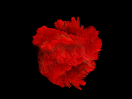 Explosion of red powder isolated on black backgroundの写真素材