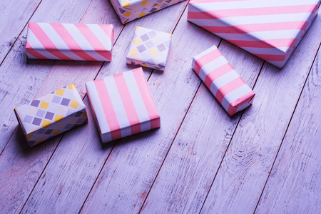 craft paper present boxes on wooden background with copy space, color filters in soft color.の写真素材