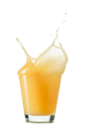 splash of apple or quince juice in a glass isolated on white background.の写真素材