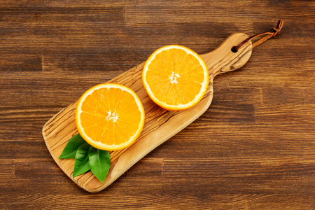 Juicy ripe oranges on wooden background, top view.の写真素材