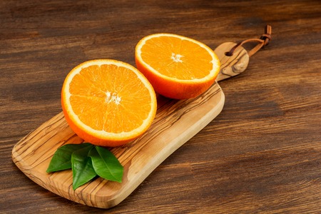 Orange on a wooden background. Top view. Free space for text.