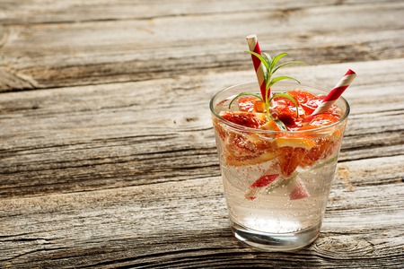 Cold refreshing summer lemonade in a glass on a rustic wooden vintage backgroundの写真素材