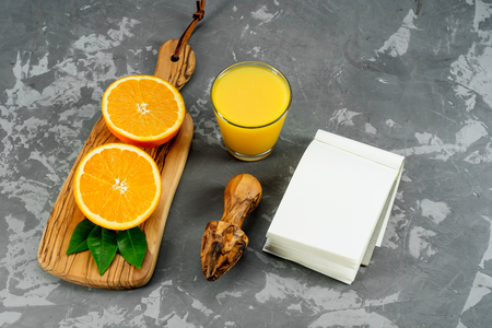 Glass of orange juice from above on concrete background. Fruit product display .の写真素材