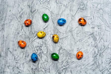 Colorful Easter eggs on concrete background with copy space .