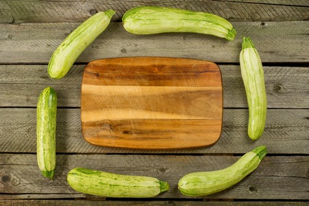 Light green fresh zucchini stacked, farm fresh produce, summer vegetables on rustic background. Top viewの写真素材