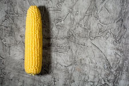 top view of fresh corn cob on a gray concrete table, top viewの写真素材