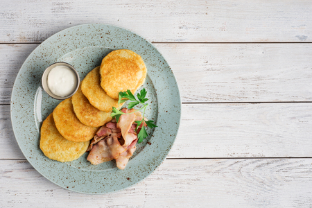 Potato pancakes or latkes on a light rustic wood surface. Flat lay food background.の写真素材