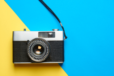 Flat lay vintage camera on colorful background with copy space .