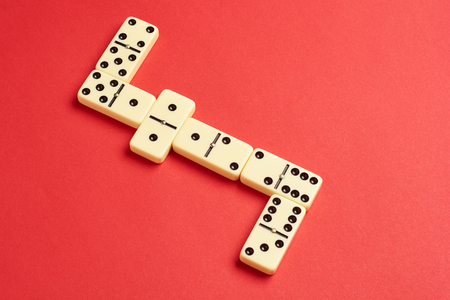 Flat lay concept. Board games publications. domino pieces on the red background with copy space .の写真素材