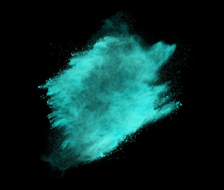 Explosion of colored powder on black backgroundの写真素材
