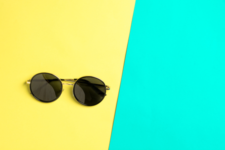 Flat lay. Fashion sunglasses on pastel background with copy space. Top view.の写真素材