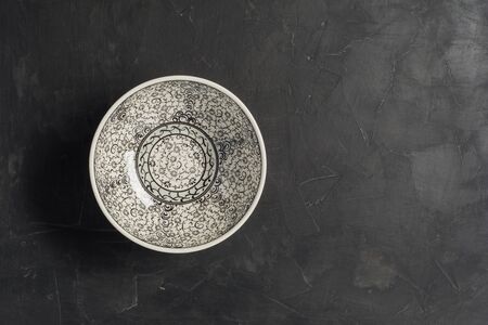 top view of traditional asian bowl on dark brown table with copy space.の写真素材