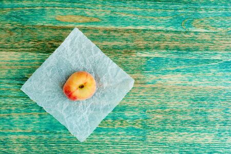 chinese flat peaches on rustic colorful background with copy space. Flat lay background.の写真素材