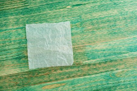 Sheet of White Thin Crumpled Craft Paper on rustic Background Top View.の写真素材