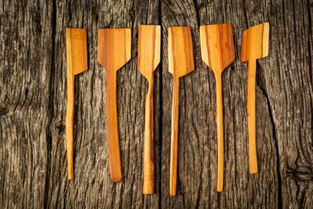 different kitchen wooden utensils close up on rustic wooden background.の写真素材