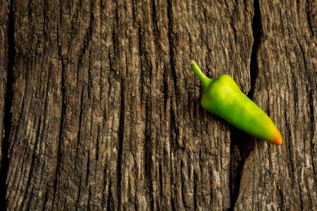 Green chili hot pepper on rustic wooden background with copy space for text
