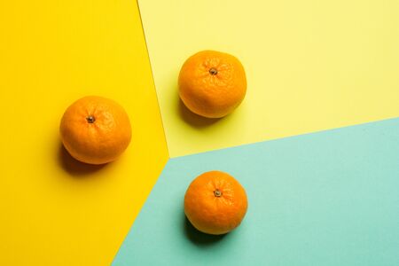 Creative pattern made of tangerines with copy space for text on bright background. Flat lay minimal...
