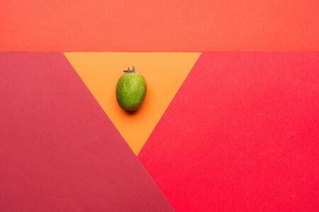 Feijoa fruit on colorful background. Top view pop art minimal flat lay styleの写真素材