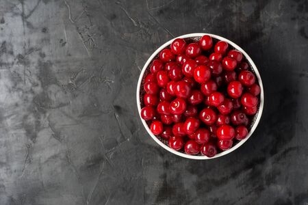 Fresh cherries in bowl on table. Flat lay backgroundの写真素材