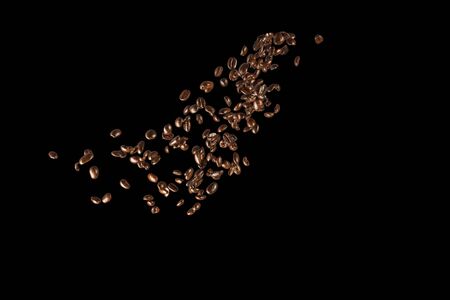 Coffee Beans splashing isolated on black backgroundの写真素材