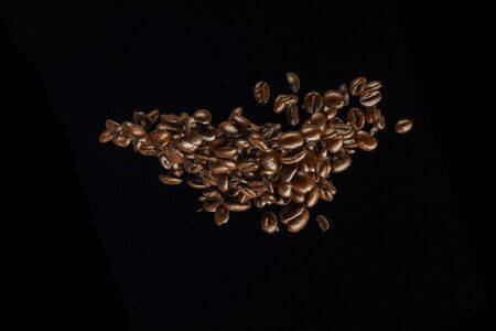 Coffee Beans flying isolated on black background.の写真素材
