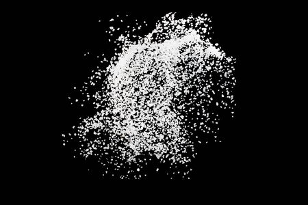 Sea salt explosion isolated on black background close upの写真素材