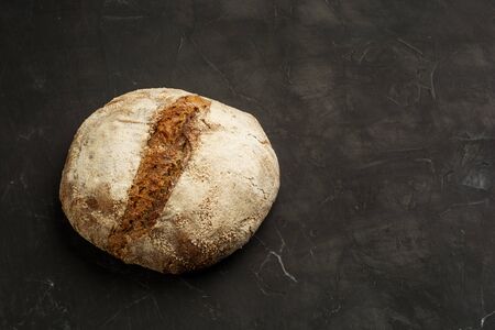 Traditional black rye-bread on dark table with copy spaceの写真素材