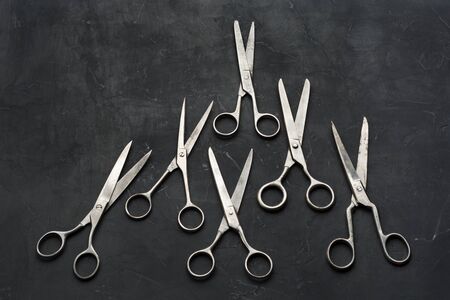 Old scissors on dark background background. Minimal blackの写真素材