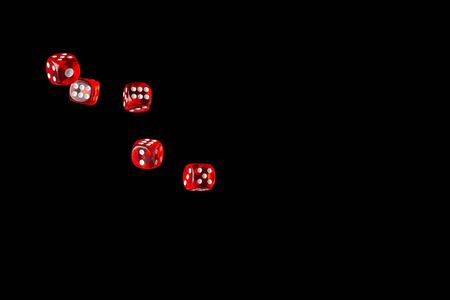 Let`s play a diced game. Dice in air isolated on black background.の写真素材