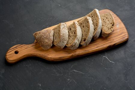Freshly baked homemade artisan sourdough rye and white flour bread. Slice. Close up. Copy space.の写真素材